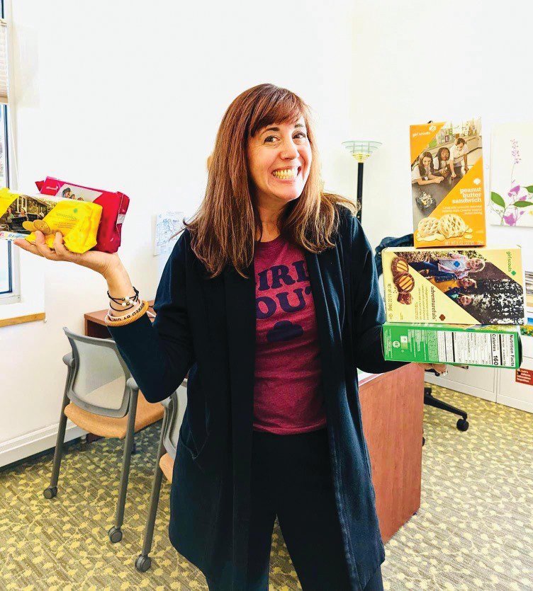 IT’S COOKIE SEASON: Girl Scouts of Southeastern New England (GSSNE) CEO Dana Borrelli-Murray poses with some of the Girl Scout cookie options available for purchase. The organization is currently in cookie season and, last year, the GSSNE council sold 750,000 cases of cookies; each case holds 12 boxes. (Submitted photo)